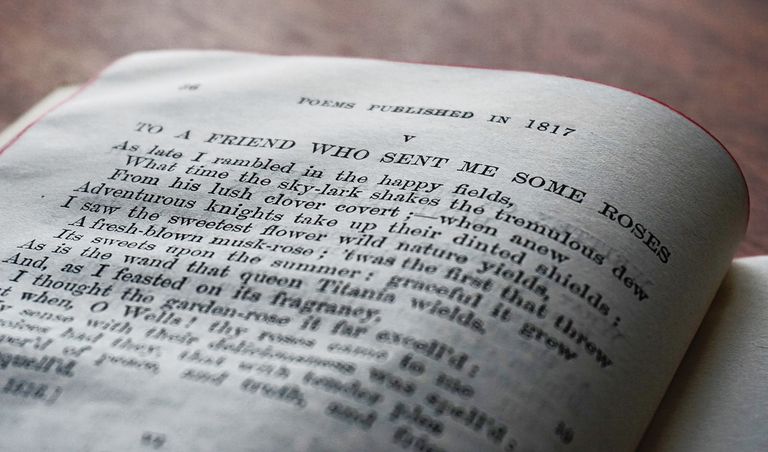 Close-up of a vintage book page with a poem published in 1817.